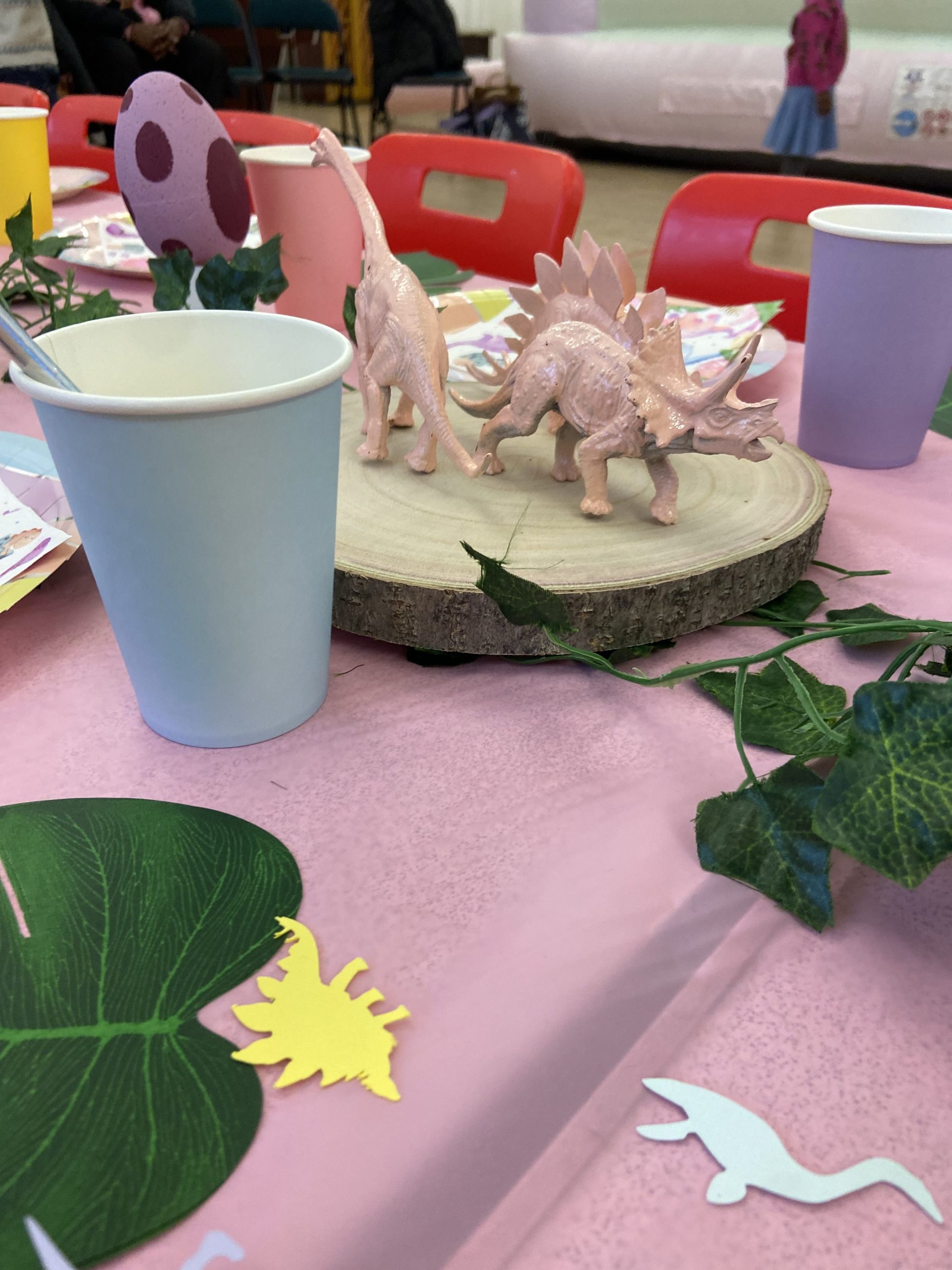 Kids party table for a girls birthday party, with a theme of prehistoric princess.